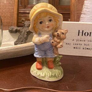 Little girl figurine holding dog